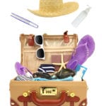 Ready to travel open suitcase with summer equipment isolated