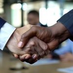 Business handshake close-up, partners shaking hands for agreement approval